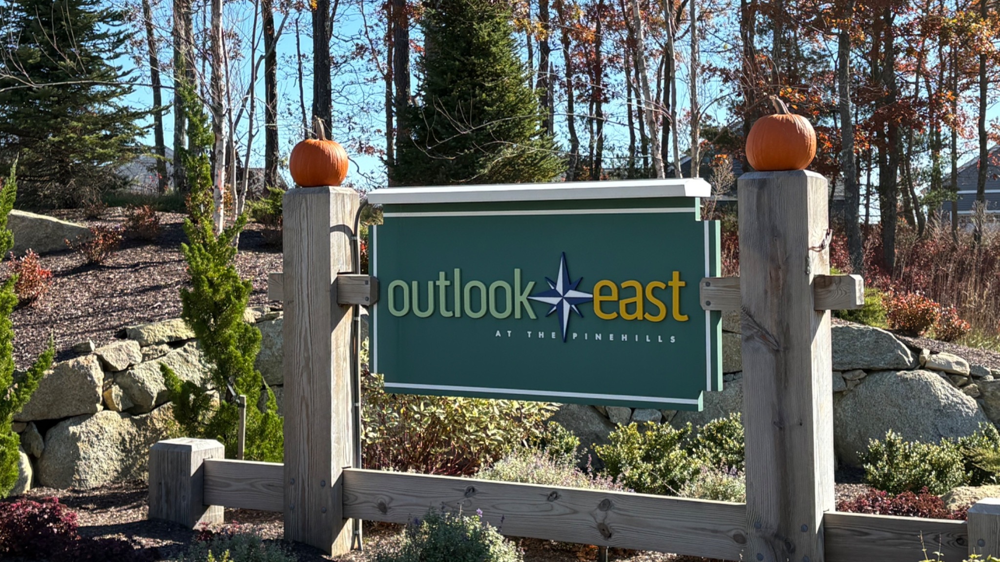 Outlook East entrance sign with two autumn pumpkins